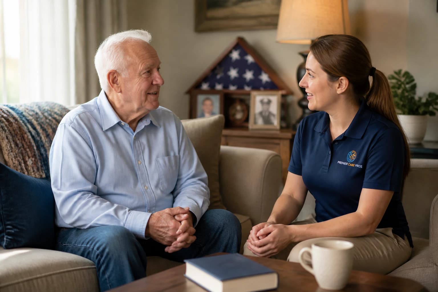 An older veteran talking with a caregiver in his home